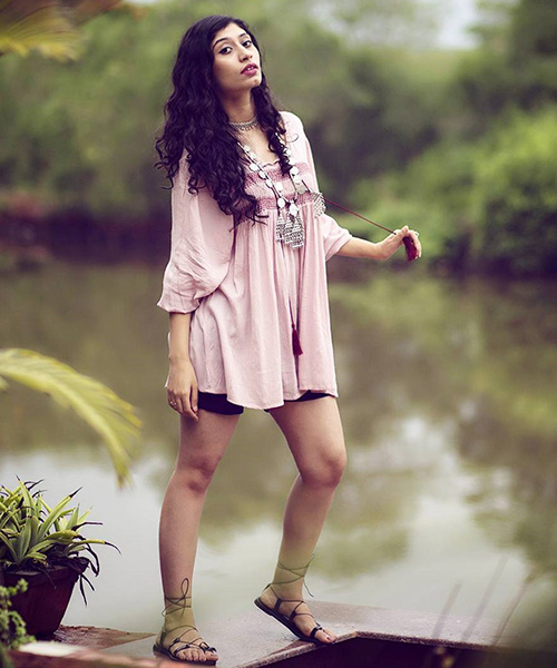 Short boho dress on a girl in light sandals